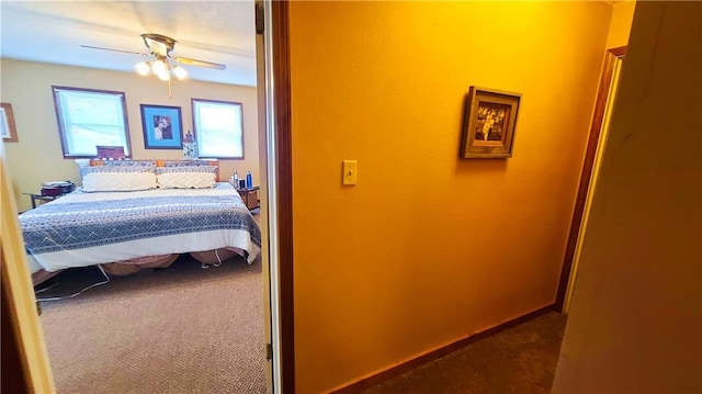 carpeted bedroom with a ceiling fan and baseboards