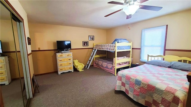 bedroom with carpet flooring, a ceiling fan, baseboards, and a closet