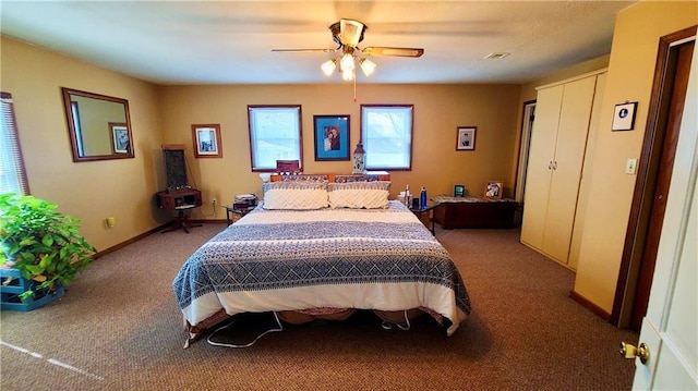 bedroom with ceiling fan, carpet, and baseboards