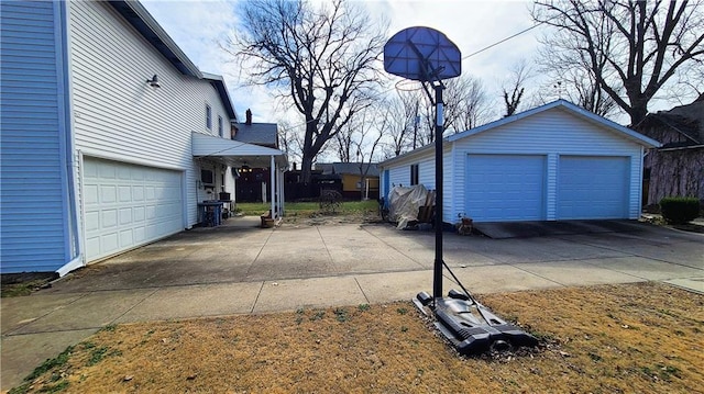 view of property exterior featuring a detached garage and an outbuilding