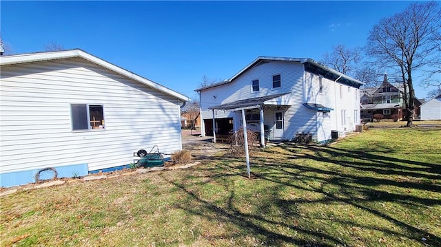 back of house with a lawn