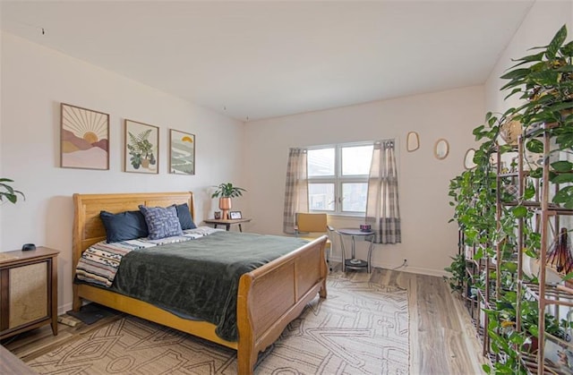 bedroom featuring light wood-type flooring and baseboards