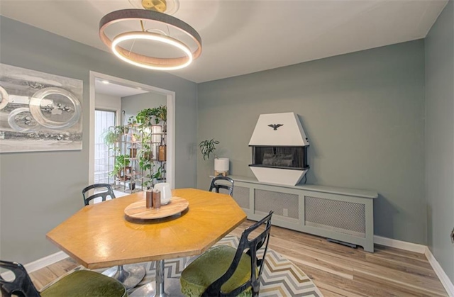 dining space featuring wood finished floors and baseboards