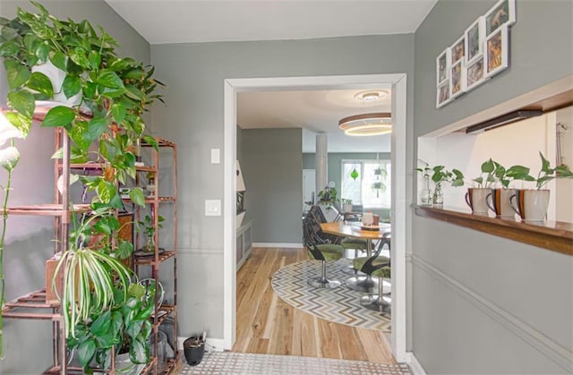 interior space featuring light wood-style flooring and baseboards