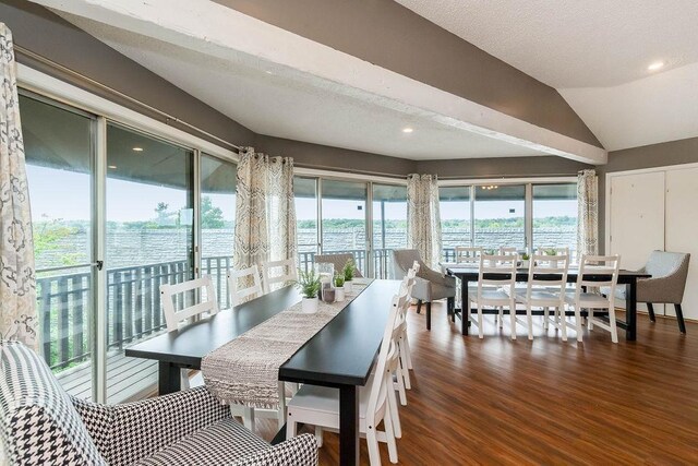 dining space with vaulted ceiling and wood finished floors