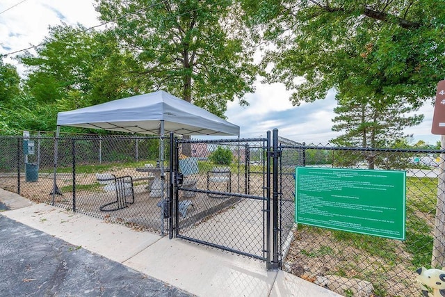 view of property's community featuring fence and a gate