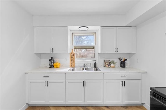 bar with a sink, baseboards, and light wood-style flooring