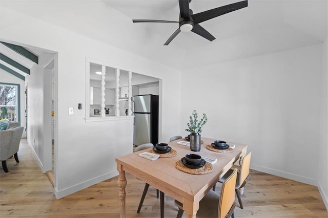 dining space with baseboards, light wood-type flooring, and a ceiling fan