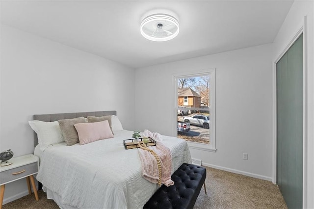 bedroom featuring baseboards, carpet floors, and visible vents