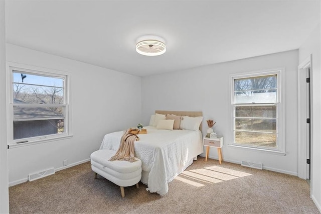 carpeted bedroom with visible vents and baseboards