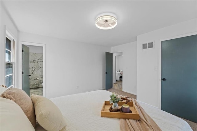 bedroom with visible vents, baseboards, and carpet