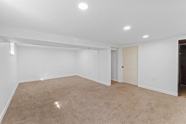 finished basement with recessed lighting, baseboards, and carpet