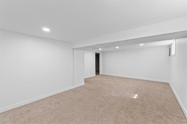 finished below grade area with recessed lighting, baseboards, and light carpet