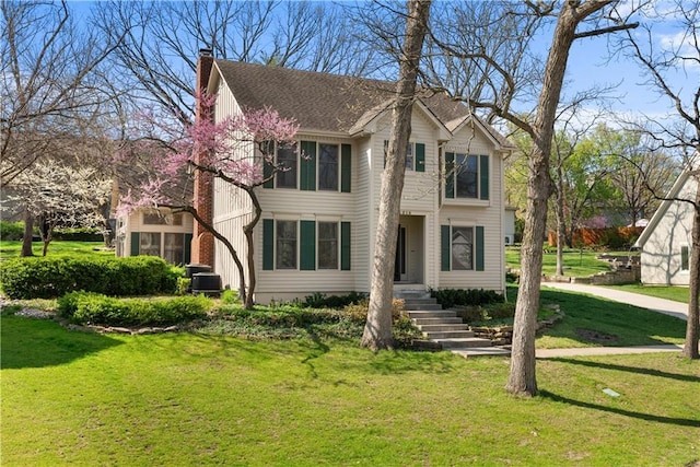 view of front of house with a front yard and a chimney