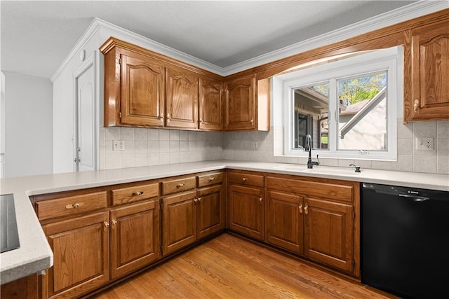 kitchen featuring light countertops, black dishwasher, light wood-style floors, brown cabinetry, and a sink