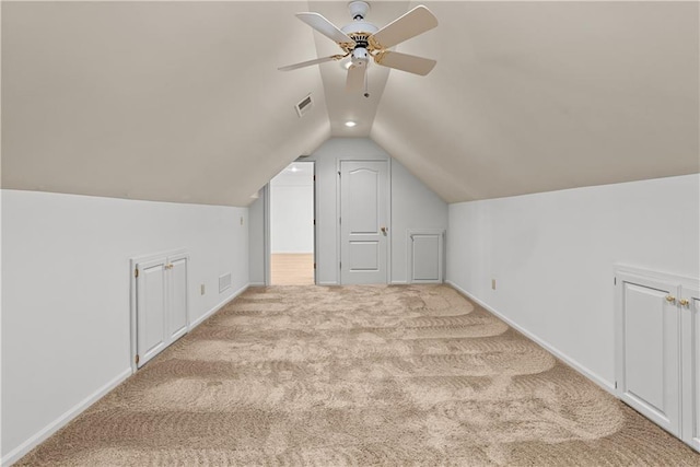 additional living space with a ceiling fan, vaulted ceiling, visible vents, carpet flooring, and baseboards