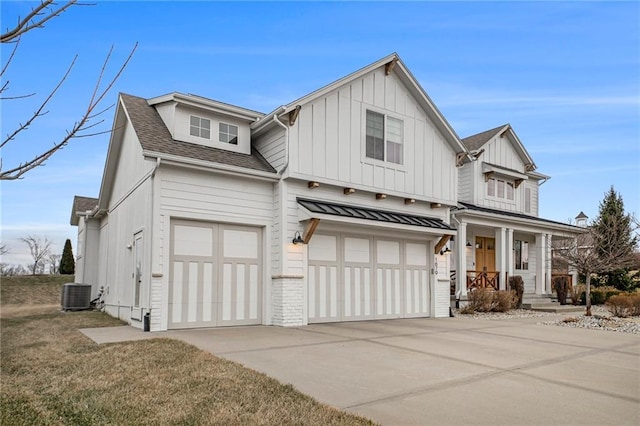 modern farmhouse featuring roof with shingles, an attached garage, central AC unit, board and batten siding, and driveway