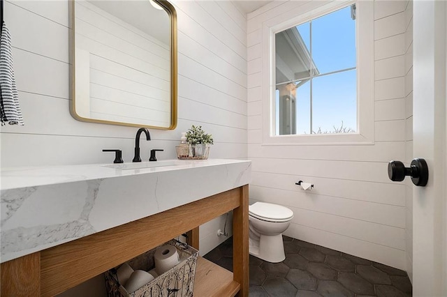 bathroom featuring tile patterned flooring, vanity, and toilet