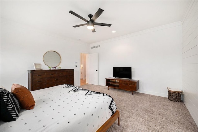 bedroom with ornamental molding, carpet flooring, visible vents, and a ceiling fan