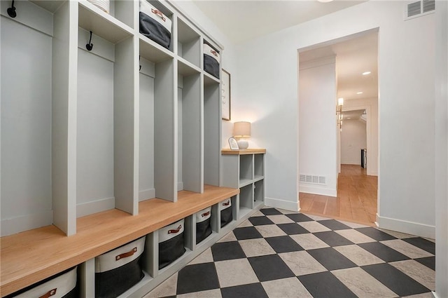 mudroom with baseboards, visible vents, and tile patterned floors