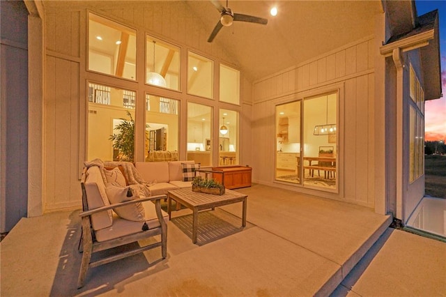 sunroom featuring a ceiling fan and lofted ceiling