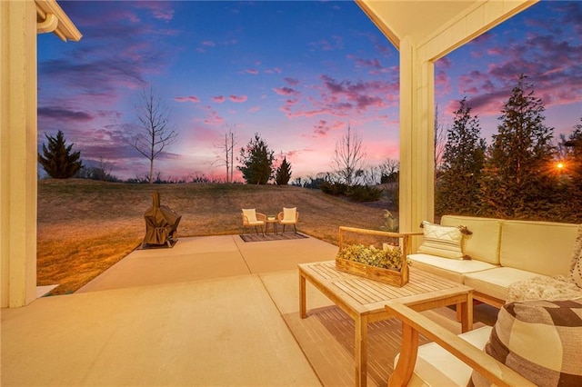 patio terrace at dusk featuring an outdoor hangout area