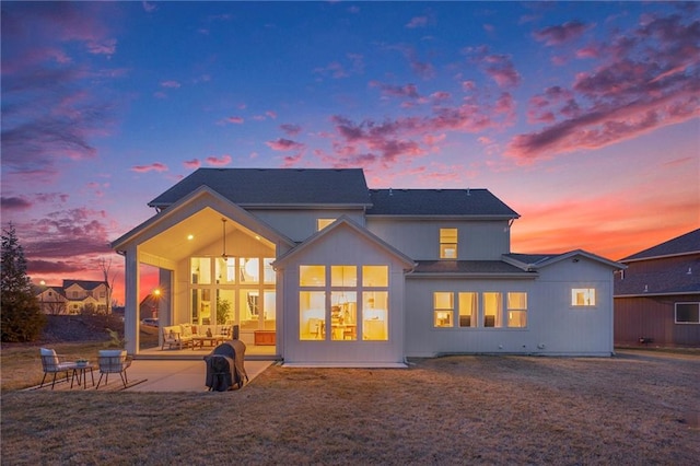 rear view of property featuring a patio area and a yard