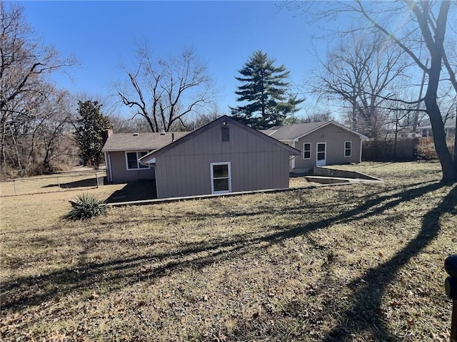 rear view of property with fence