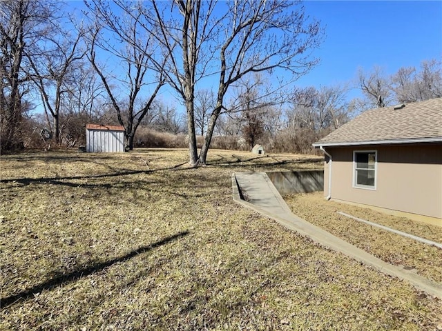 view of yard featuring an outbuilding and a shed