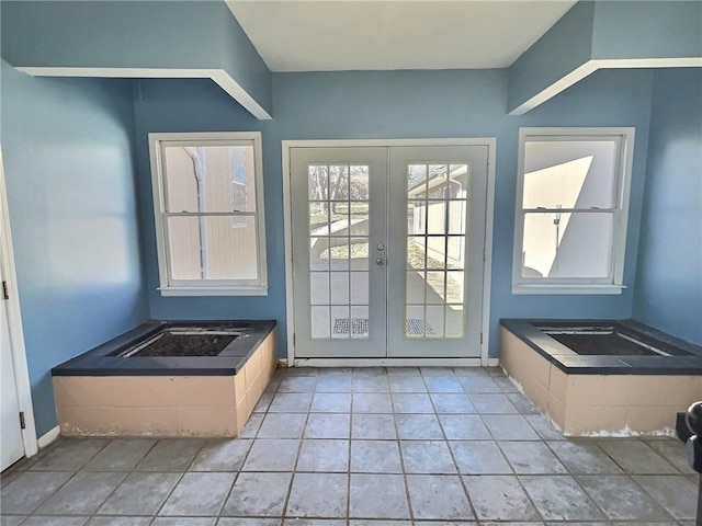 doorway featuring french doors and light tile patterned flooring