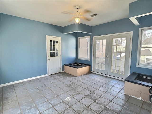 doorway with baseboards, visible vents, a ceiling fan, french doors, and light tile patterned flooring