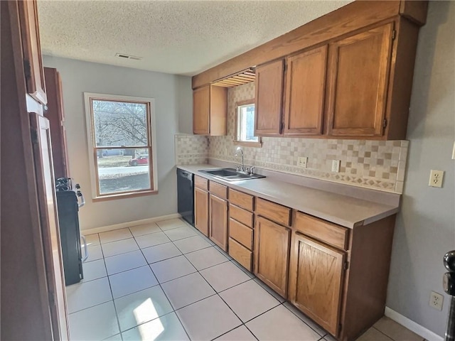 kitchen featuring decorative backsplash, visible vents, a sink, and dishwasher