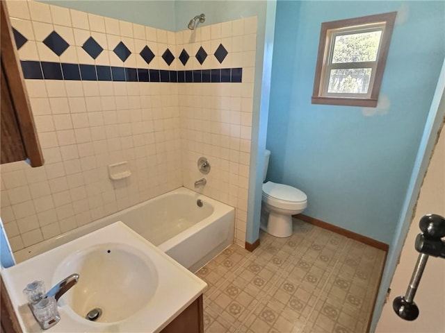 full bath with toilet, bathtub / shower combination, baseboards, and vanity