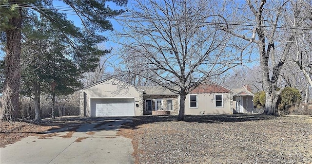 ranch-style home with driveway and an attached garage