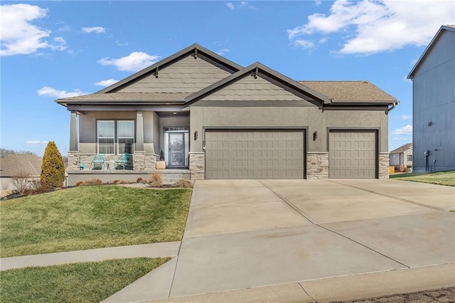 craftsman house with an attached garage, stone siding, driveway, stucco siding, and a front yard