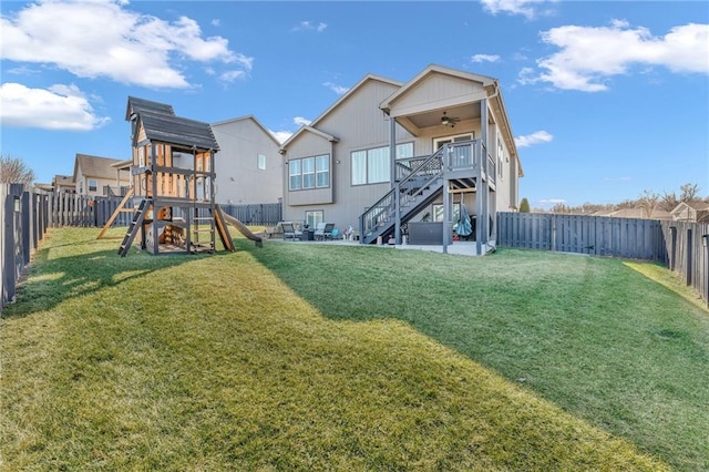 exterior space featuring a yard, a fenced backyard, a patio, and stairway