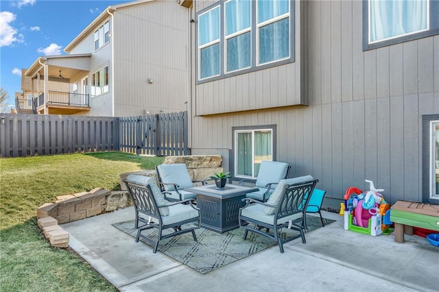 view of patio featuring outdoor lounge area and fence