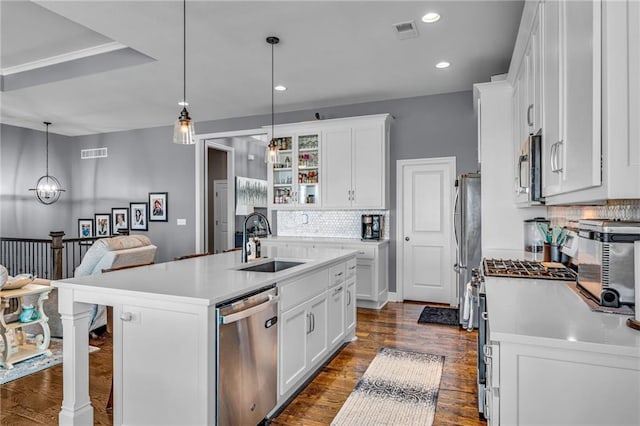 kitchen featuring stainless steel appliances, white cabinets, visible vents, and a sink