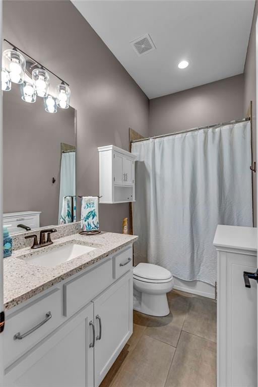 full bathroom featuring shower / bath combo, visible vents, toilet, tile patterned flooring, and vanity