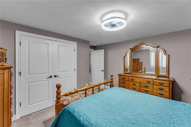 bedroom with a closet, carpet flooring, and a textured ceiling