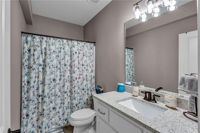 bathroom with visible vents, a shower with shower curtain, vanity, and toilet