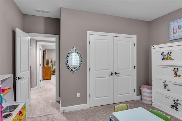 recreation room with light carpet, baseboards, and visible vents