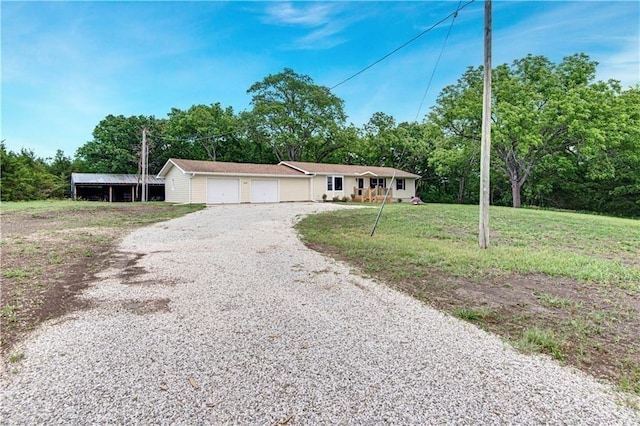 ranch-style home with a front lawn, an attached garage, and gravel driveway