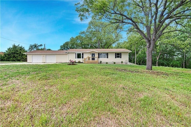 single story home with a garage and a front lawn