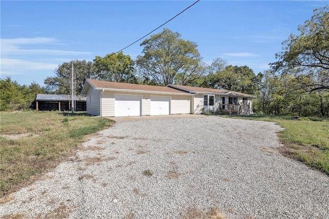 ranch-style house with driveway and a garage