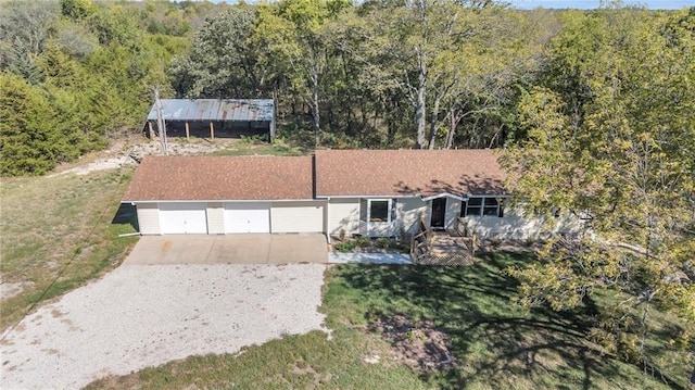 drone / aerial view featuring a wooded view