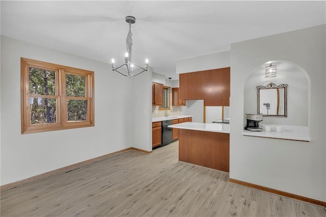 kitchen with baseboards, brown cabinetry, dishwasher, light countertops, and light wood-style floors