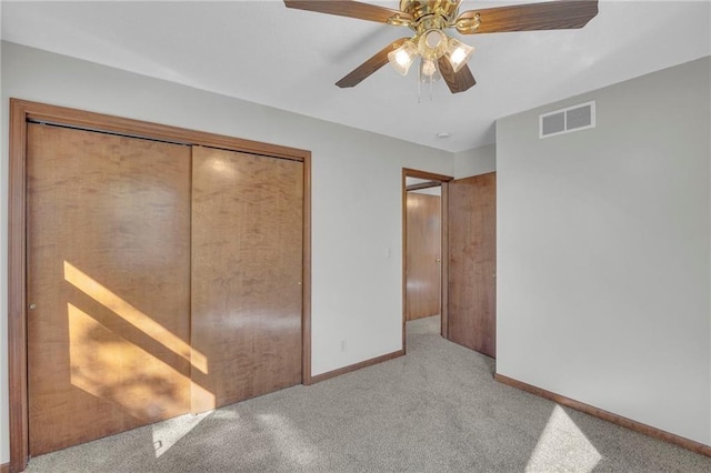 unfurnished bedroom featuring visible vents, baseboards, ceiling fan, carpet, and a closet