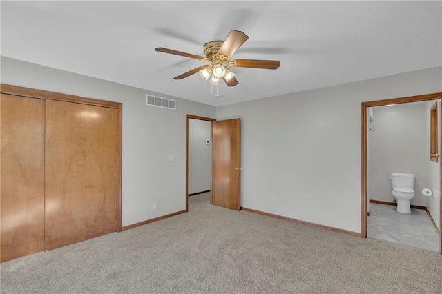 unfurnished bedroom featuring a closet, baseboards, visible vents, and carpet flooring