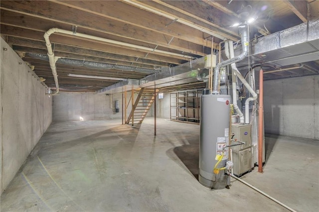 unfinished basement featuring stairway and gas water heater